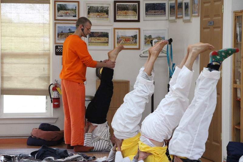 Teacher assisting students in the yoga class.