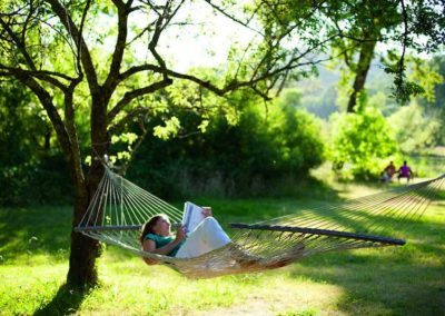 Practicing the art and science of relaxation lying in a hammock in nature at the Sivananda yoga farm