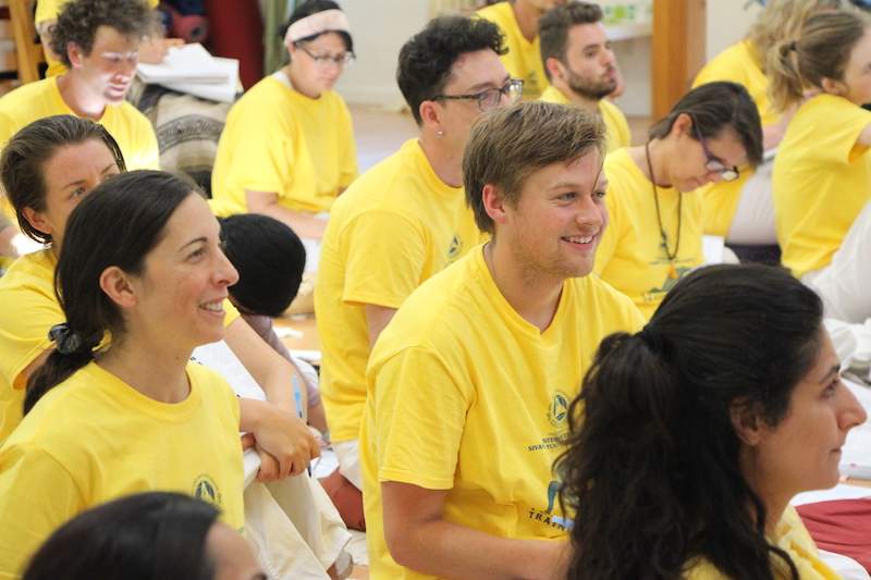 students in lecture smiling and learning