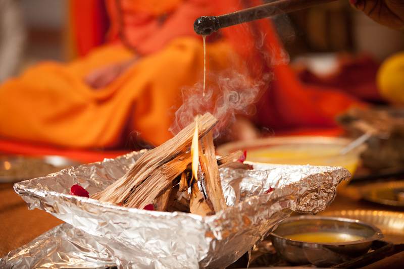Homa fire ceremony with ghee offering into the fire