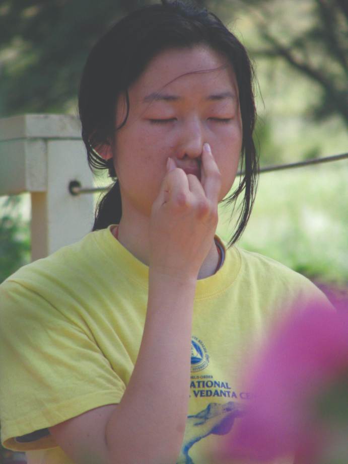 A student practices Anuloma Vilmoma (alternate nostril breathing)