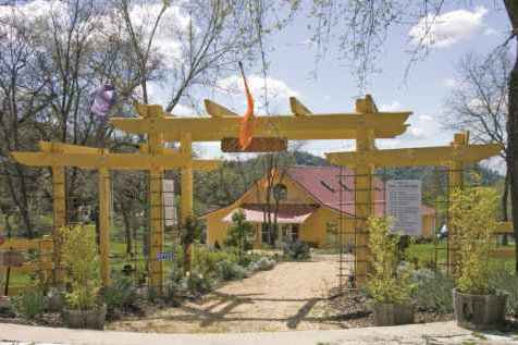 Entrance to the Yoga Farm with yellow fence and blue sky