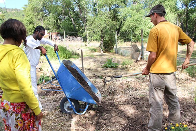 During permaculture courses at the Yoga Farm, participants learn how to sheet mulch and make hugelkultur beds.