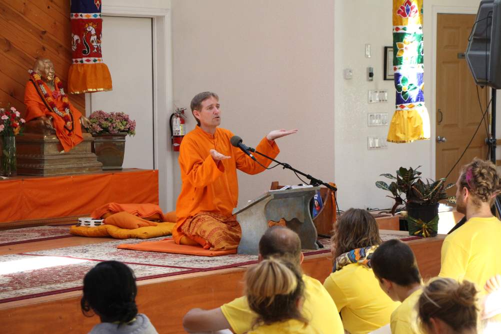 Swami Dharma teaching with hands up
