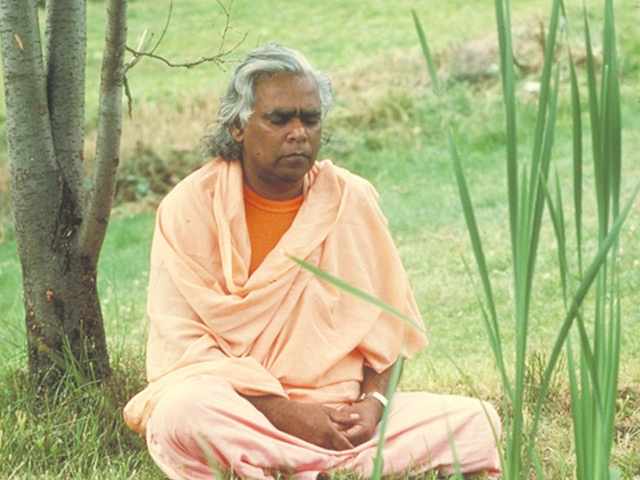 Swami Vishnudevananda meditating in Nature